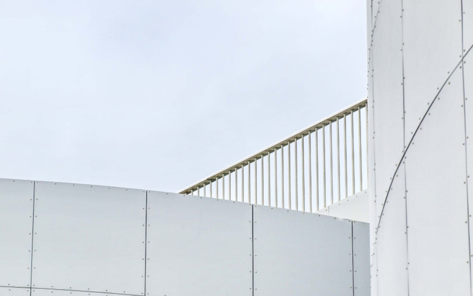 Plain white cladding and roofline of an industrial building