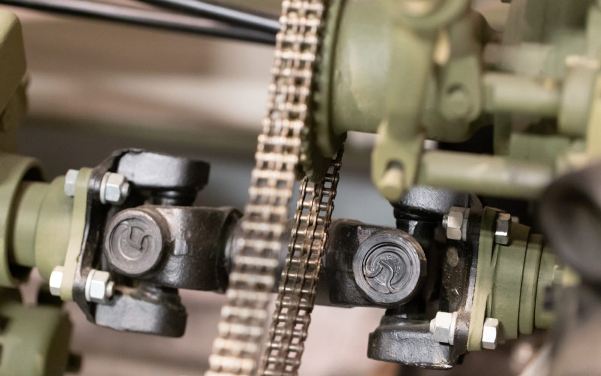 Close-up of machined metal parts and a chain drive on a machine